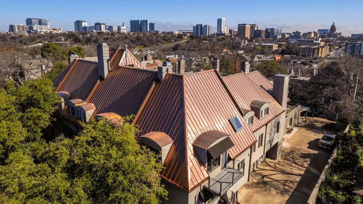 Aerial view of a copper standing seam metal roof installed by Texas Traditions Roofing in Central Texas