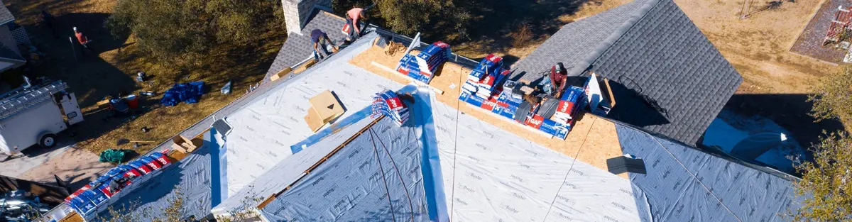 Texas Traditions Roofing crew installing underlayment during a roof replacement