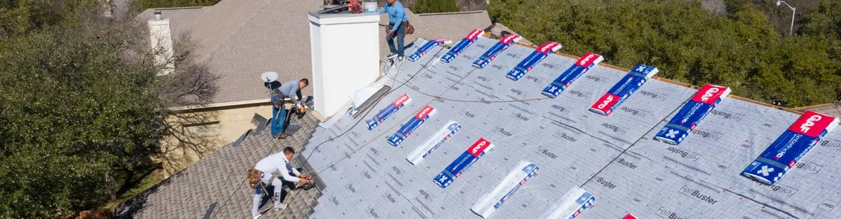 Aerial view of a Texas Traditions Roofing crew installing underlayment