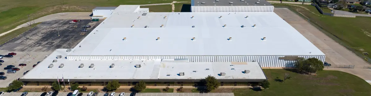 White TPO commercial roof installed by Texas Traditions Roofing in Central Texas
